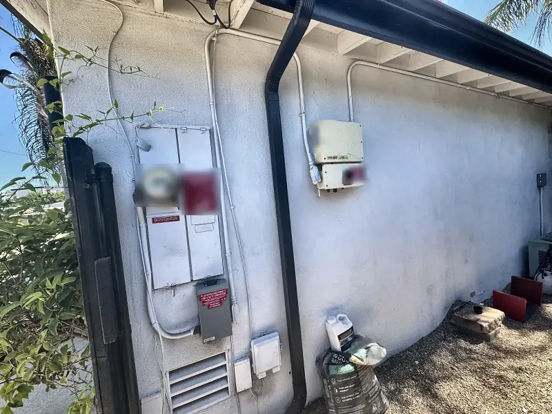 Older main electrical panel with solar disconnect on a San Diego home