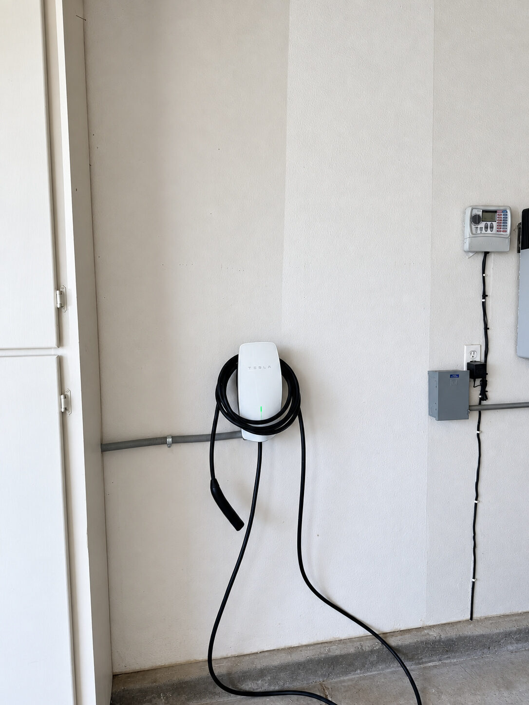Tesla Wall Connector mounted inside a residential garage